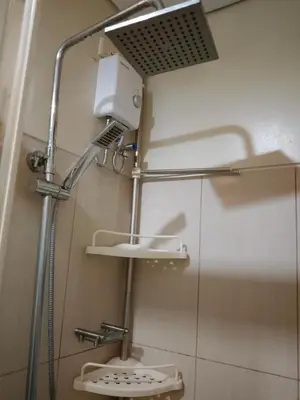 a bathroom with a shower and a toilet in a room at Dmjs staycation in Manila