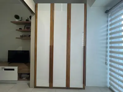 a sliding glass door in a room with a tv at Makati High rise 1 Bedroom Condo with Balcony in Manila