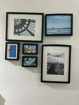 a group of pictures hanging on a wall at Makati High rise 1 Bedroom Condo with Balcony in Manila