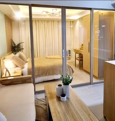 a bedroom with a bed and a table in a room at Azure urban resort residences, BAHAMAS tower Japandi model in Manila