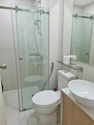 a bathroom with a shower and a toilet and a sink at Azure urban resort residences, BAHAMAS tower Japandi model in Manila