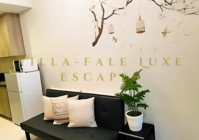 a living room with a bench and a sign on the wall at 1 Bed Room Coast Residence at Heart of Metro Manila - Pasay City in Manila