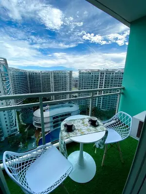 a balcony with a table and chairs and a view of a city at Azure Staycation by the clouds in Manila