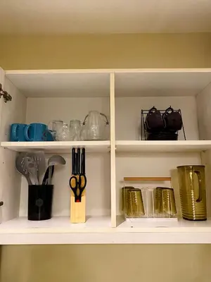 a white shelf with utensils on it at Azure Staycation by the clouds in Manila