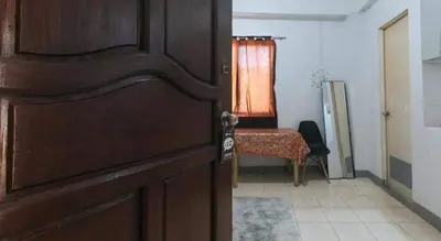 a door to a room with a table and a chair at Marco's Economy Room For Rent near NAIA in Manila