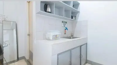 a white kitchen with a counter and a sink at Marco's Economy Room For Rent near NAIA in Manila