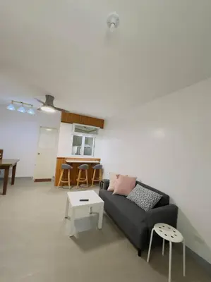 a living room with a couch and a table at Homestay at Phirst Park Homes Tanza in Tanza