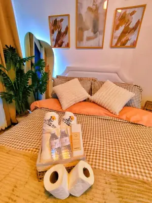 a bed with two rolls of toilet paper on it at Azure Staycation by Oveecation Suites in Manila