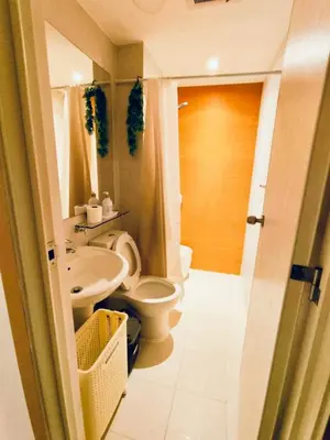 a bathroom with a toilet and a sink at Azure Staycation by Oveecation Suites in Manila
