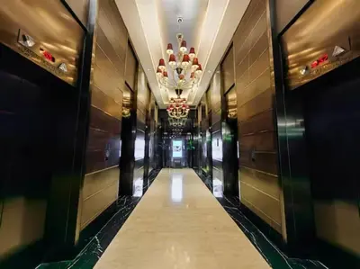 a hallway of a hotel with a chandelier at 66F 1 BR Penthouse with 2 Balconies Panoramic View in Manila