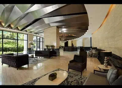 a large lobby with couches and chairs and tables at 66F 1 BR Penthouse with 2 Balconies Panoramic View in Manila