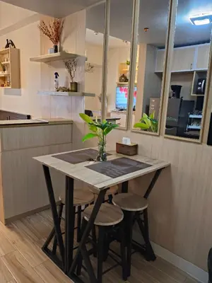 a table in a kitchen with a vase on it at Tessa's Place Staycation 4FI in Jalang