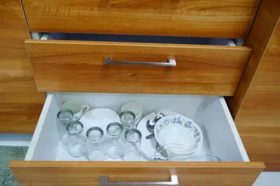 a drawer with a bunch of dishes and cups at Studio 203 T2 Sunshine100 Wifi PoolAccess BunkBed SofaBed in Manila