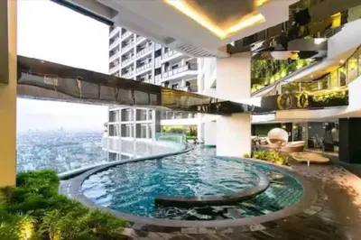 a swimming pool in the middle of a building at 58F Minimalist Studio Panoramic View in Gramercy in Manila