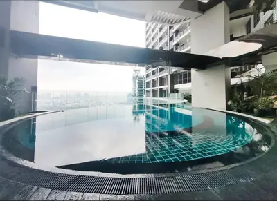 a swimming pool in the middle of a building at 64F Spacious 1 BR Nice View Pool Sauna Gym in Manila