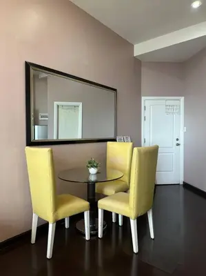 a dining room with a table and two chairs and a mirror at 68F 1 Bedroom Penthouse Suite Gramercy Pool Sauna in Manila
