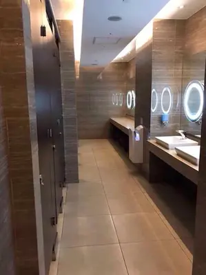 a bathroom with two sinks and two mirrors at 45F Gramercy Corner Studio Wifi Netflix SmartTV free use Pool Gym in Manila