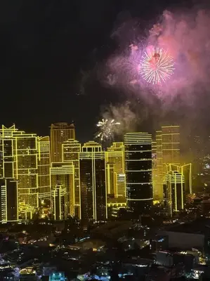 a fireworks display in a city with buildings at Penthouse Studio Highspeed Wi Fi Smart TV Pool GYM in Manila