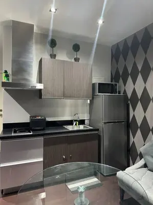 a kitchen with a glass table in a kitchen at Penthouse Studio Highspeed Wi Fi Smart TV Pool GYM in Manila