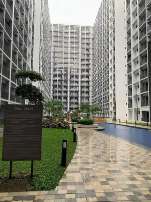 a sign in the middle of a city with tall buildings at Straightforward 1 BR Shore 2 Residences near MOA NAIA PICC in Manila