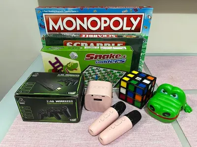 a box of monopoly and other toys on a table at Straightforward 1 BR Shore 2 Residences near MOA NAIA PICC in Manila