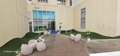 a group of white pots sitting outside of a building at Makati Bliss Apartment - Cozy Urban Retreat in Manila