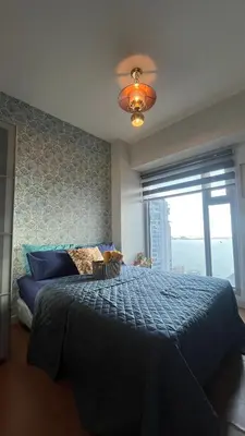 a bedroom with a large bed and a window at 8Adriatico Penthouse Studio Unit! Walk Away to US Embassy and St Lukes Ermita in Manila