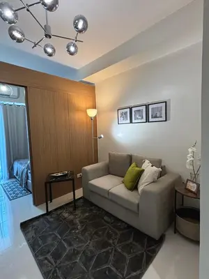a living room with a couch and a table at Cozy Space in Makati - Margareth Suite in Manila