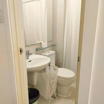a bathroom with a toilet and a sink and a mirror at Azure Playfull Living 1 bedroom in Manila