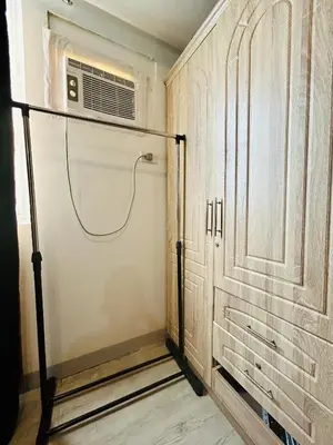 a room with a closet with a fan and a door at Cozy Studio Unit Near MRT Shaw & Malls in Manila