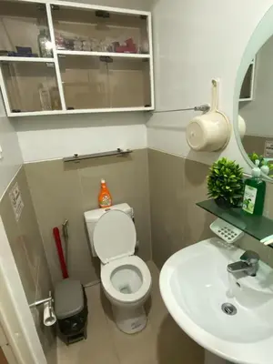 a small bathroom with a toilet and a sink at Marlouise Place Beacon T1 in Manila