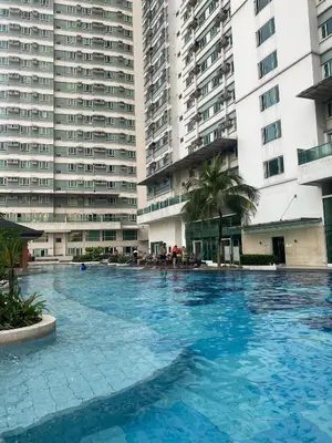 a large swimming pool in front of tall buildings at Marlouise Place Beacon T1 in Manila