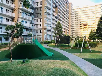 a playground with a slide in a apartment complex at Condo Staycation - Kanlungan by Anna at Satori Residences, Pasig in Manila
