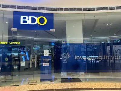 a bdo store window with a sign on it at Cozy 1BR nr Ortigas Makati & BGC with Secured Parking in Manila