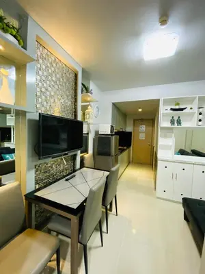 a kitchen and dining room with a table and chairs at 7J HomeStay at Sea Residences MoA Manila in Manila