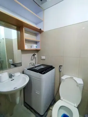 a bathroom with a toilet and a sink at Comfystay at Shell Residences in Manila
