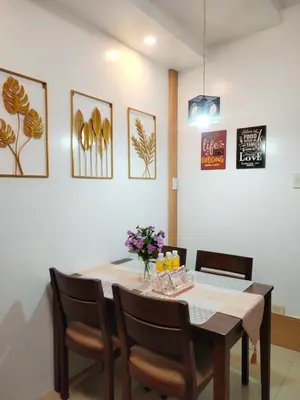 a dining room with a table and chairs at Comfystay at Shell Residences in Manila
