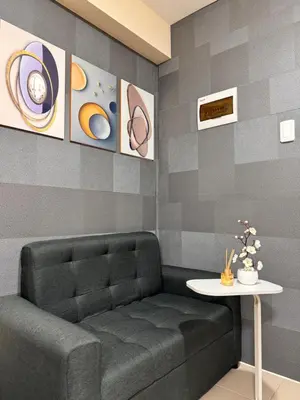a waiting room with a bench and a table at VR Homes Ortigas - 2BR Condo with Free WiFi & Netflix in Manila