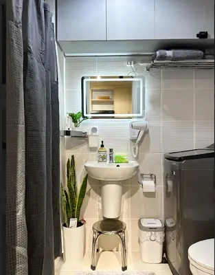 a small bathroom with a sink and a toilet at Suite 101F a New & Spacious MOA Sunrise Drive Oasis in Manila
