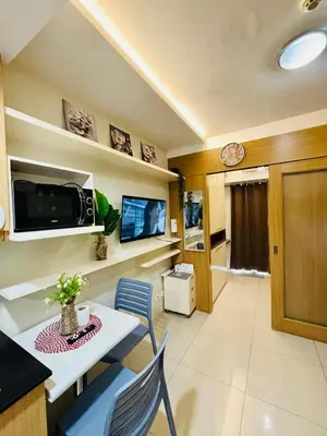 a kitchen and dining room with a table and chairs at Condotel By RhoiVC in Shell Residences Moa Near Naia Airport in Manila