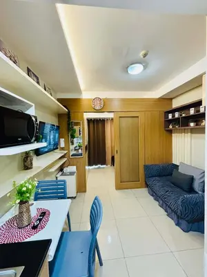 a living room with a couch and a table at Condotel By RhoiVC in Shell Residences Moa Near Naia Airport in Manila