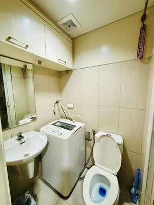 a small bathroom with a toilet and a sink at Condotel By RhoiVC in Shell Residences Moa Near Naia Airport in Manila