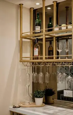a shelf filled with wine glasses and wine bottles at Lamour Talia in Manila