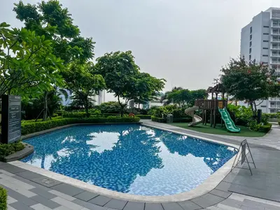 a swimming pool with a slide and a playground at BRAND NEW Casa Airabella with Netflix & Makati City Skyline in Manila