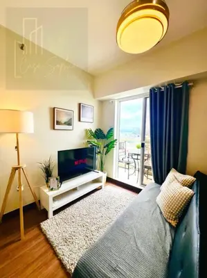 a living room with a bed and a television at CASA SOPHIA Affordable Condo Near Bonifacio Global City BGC CBD in Manila