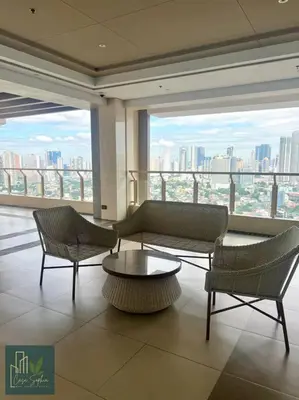 a room with two chairs and a coffee table in a building at CASA SOPHIA Affordable Condo Near Bonifacio Global City BGC CBD in Manila