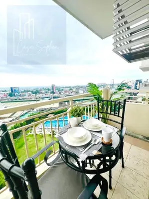 a table and chairs on a balcony with a view at CASA SOPHIA Affordable Condo Near Bonifacio Global City BGC CBD in Manila