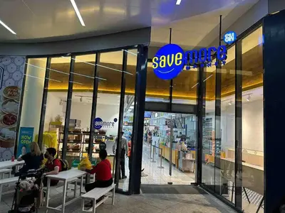 people sitting at tables outside of a save meat store at Air Residences - Panoramic City View near Airport - 2932 in Manila