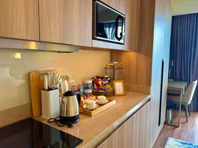 a kitchen counter with a coffee maker on it at The Residences at Novotel Tower in Manila
