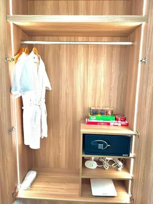 a closet with a wooden wall with a shelf and a drawer at The Residences at Novotel Tower in Manila